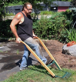 Rich Oliver of Perennial Harmony, Waterford, CT uses a manual "sod kicker" to clear ground. 